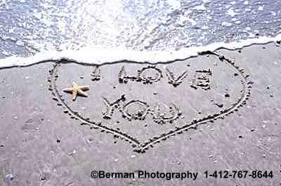 sequence photographs of heart washing away in the sand